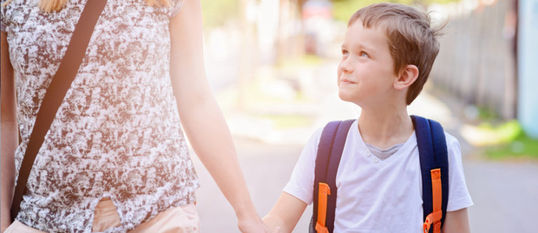 child holding hands with mom going to school in florida