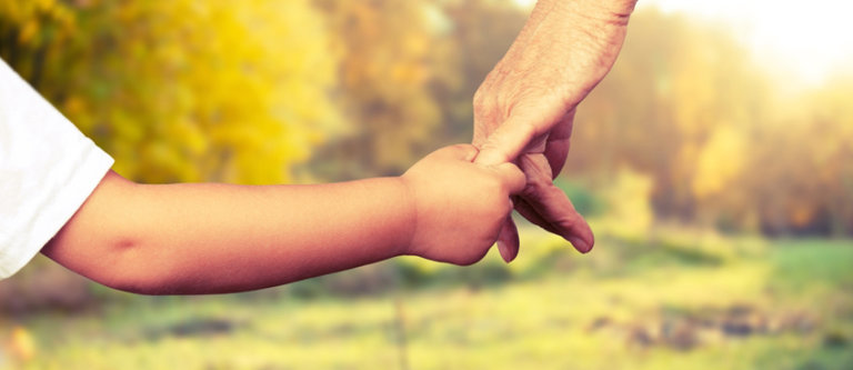 father and son holding hands