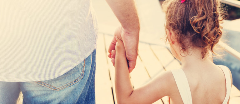 Parent holding child's hand