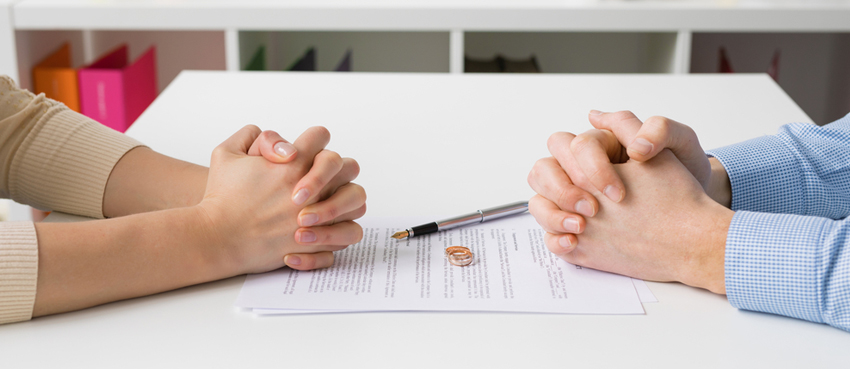 two people praying over divorce papers