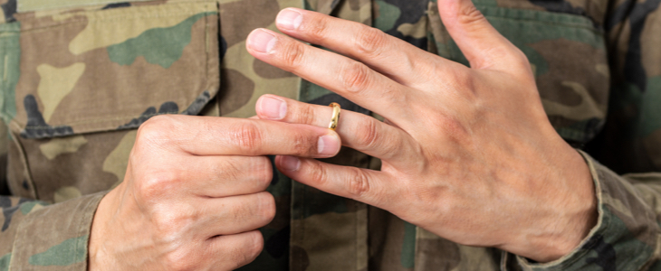 Military officer removing wedding ring in military divorce