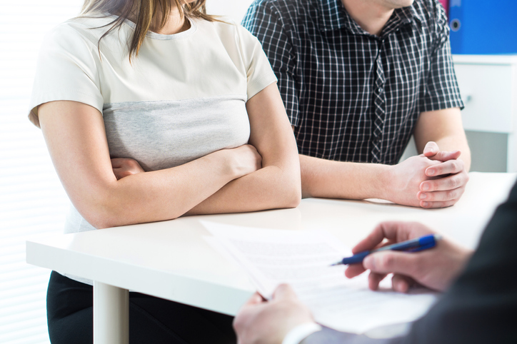 Married couple meeting with family law attorney
